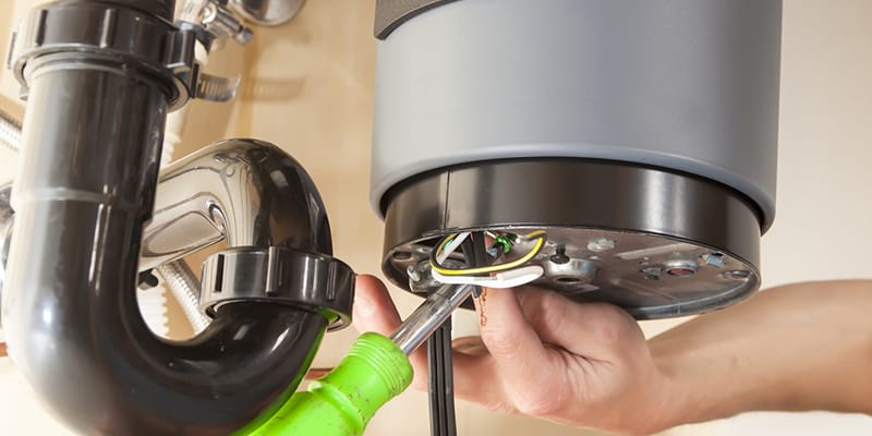 Technician repairing the heating element of a water heater in New Castle